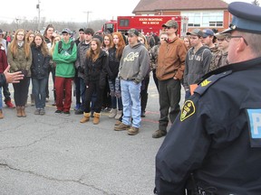 Const. Roop Sandhu, left, with the Ontario Provincial Police Frontenac detachment, talks to Sydenham High School students about winter driving safety during a workshop in Sydenham on Wednesday. (Michael Lea/The Whig-Standard)