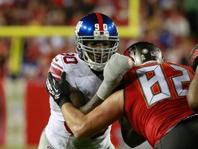 New York Giants defensive end Jason Pierre-Paul (90) rushes the passer as Tampa Bay Buccaneers tight end Brandon Myers (82)  blocks during NFL action at Raymond James Stadium. (Kim Klement/USA TODAY Sports)