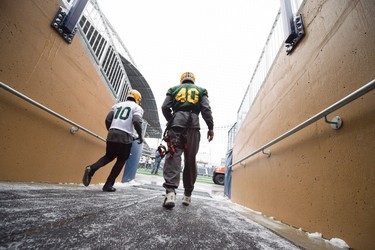 Edmonton Eskimos Deon Lacey (right) and Chad Simpson make their way to the field during a team practice in Winnipeg, Man. Wednesday, Nov.25, 2015. The Eskimos will play the Ottawa Redblacks in the 103rd Grey Cup Sunday. THE CANADIAN PRESS/Nathan Denette