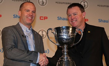 Ottawa RedBlacks head coach Rick Campbell, shakes hands with Edmonton Eskimos head coach Chris Jones  before the start of the coach's news conference during Grey Cup week in Winnipeg, MB, on Wednesday November 25, 2015. The Edmonton Eskimos will play the Ottawa Redblacks next Sunday at Investors Group Field in the 103rd Grey Cup. Al Charest/Calgary Sun/Postmedia Network