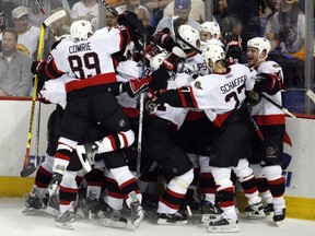 Members of the Ottawa Senators celebrate after Senators' Daniel Alfredsson scored the winning goal during overtime in Game 5 of the NHL's Eastern Conference final hockey series in Buffalo, New York, May 19, 2007.  With the win the Senators advance to the Stanley Cup.