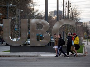 Young men walk past large letters spelling out UBC at the University of British Columbia in Vancouver, B.C., on November 22, 2015. THE CANADIAN PRESS/Darryl Dyck