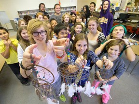 Lorne Avenue Public School pupils Natasha Didine-Lacelle and Emma Brown hold some of the dreamcatchers made by grade 6, 7 and 8 pupils to raise funds for Syrian refugees, in the library at Lorne Avenue public elementary school. (CRAIG GLOVER, The London Free Press)