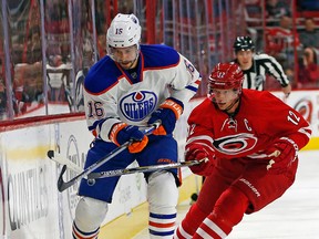 Oilers forward Teddy Purcell battles with Hurricanes Eric Staal for the puck during the first period of Wednesday's game in Raleigh, N.C. (AP Photo)