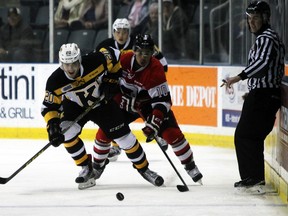 Kingston Frontenac's captain Roland McKeown battles Ottawa 67's Jeremiah Addison for the puck in the first period of Ontario Hockey League action at the Rogers K-Rock Centre in Kingston, Ont. on Wednesday November 25, 2015. Steph Crosier/Kingston Whig-Standard/Postmedia Network