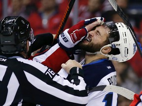 Jets right winger Anthony Peluso gets a glove to the face from Capitals right winger Tom Wilson as they scuffle on Wednesday in Washington. (AP Photo/Alex Brandon)