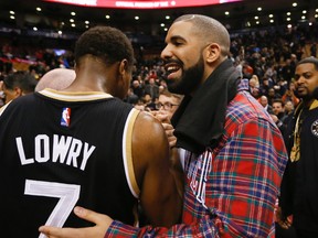 The Raptors biggest fan , Drake congratulates Kyle Lowry at the end of the game as the Toronto Raptors beat LeBron James and the Cleveland Cavaliers at the Air Canada Centre in Toronto, Ont. on Wednesday November 25, 2015. (Stan Behal/Postmedia Network)