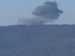 This frame grab from video by Haberturk TV, shows smoke from a Russian warplane after crashing on a hill as seen from Hatay province, Turkey, Tuesday, Nov. 24, 2015. Turkey shot down the Russian warplane Tuesday, claiming it had violated Turkish airspace and ignored repeated warnings. Russia denied that the plane crossed the Syrian border into Turkish skies. (Haberturk TV via AP)