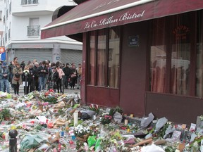 Floral tributes and messages are left at Le Carillon Hotel for victims of the Paris terrorist attacks. (WENN.com)