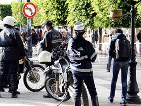 Police officers patrol in the main avenue of  Tunis, Thursday, Nov. 26, 2015.  (AP Photo/Hassene Dridi)