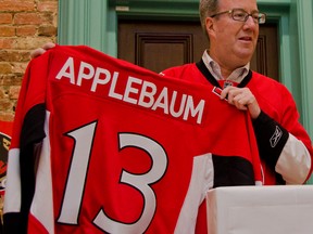 Mayor Jim Watson prepares to send Mayor Michael Applebaum a custom Senators jersey and flag for him to fly at Montreal's City Hall. Catherine Jackman/Ottawa Sun files