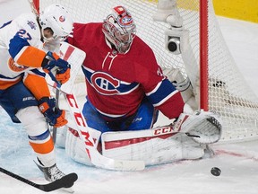 Montreal Canadiens goaltender Carey Price makes a save against the New York Islanders’ Anders Lee during NHL action in Montreal Sunday, November 22, 2015. (THE CANADIAN PRESS/Graham Hughes)