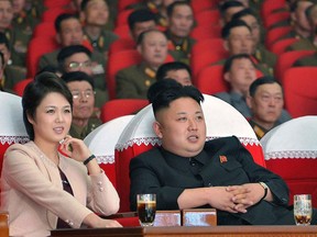 This photo taken on March 22, 2014 and released by North Korea's official Korean Central News Agency (KCNA) on March 24, 2014 shows North Korean leader Kim Jong-Un (R) and his wife Ri Sol-Ju (L) watching a performance by the Moranbong Band at the April 25 House of Culture. (AFP PHOTO/KCNA via KNS)