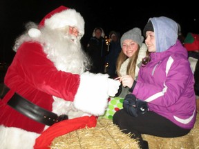 Santa determines the naughtiness or niceness of parade-goers during the 2013 Corunna Santa Claus Parade. The 2015 event takes place Saturday at 7 p.m. (File photo/ Postmedia Network)