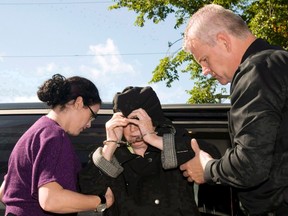 Melissa Ann Shepard, also known as the "Black Widow," leaves a Cape Breton Regional Police Services vehicle for a court appearance at the Sydney Justice Centre, Tuesday, Oct.2, 2012. The Parole Board of Canada says an elderly woman known as the "Black Widow" who was convicted of spiking her newlywed husband's coffee with tranquilizers has been denied an early release. THE CANADIAN PRESS/ Vaughan Merchant