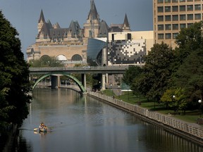 A canoe travels up the Rideau Canal in Ottawa Ontario Monday Sept 1, 2015.  Tony Caldwell/Ottawa Sun/Postmedia Network