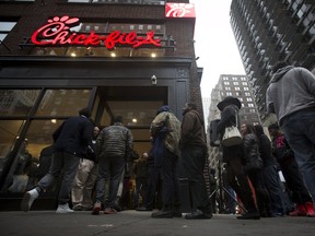 In this file phot, people stand in line for a free meal from a newly opened freestanding Chick-fil-A restaurant in the Manhattan borough of New York October 3, 2015. (REUTERS/Carlo Allegri)