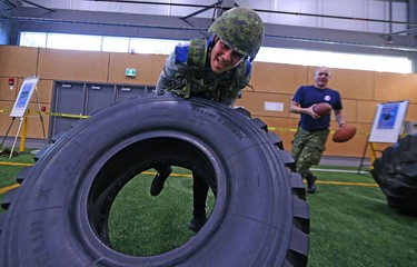 Ethan Diakow turns a tire during the MacDon Fan Experience and Family Zone at the Axworthy Health & Recplex on the University of Winnipeg campus on Thu., Nov. 26, 2015. Kevin King/Winnipeg Sun/Postmedia Network