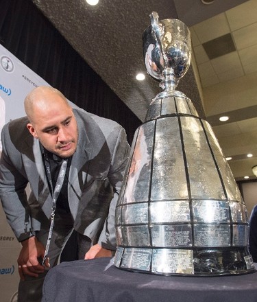 Edmonton Eskimos defensive tackle Eddie Steele looks at the Grey Cup at the West Division media lunch Thursday, November 26, 2015 in Winnipeg. The Edmonton Eskimos will play against the Ottawa RedblacksSunday in the 103rd CFL Grey Cup. THE CANADIAN PRESS/Ryan Remiorz