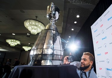 Edmonton Eskimos Andrew Jones takes a picture of the Grey Cup during the team lunch in Winnipeg, Man., on Thursday, November 26, 2015 before the up coming 103rd CFL Grey Cup game against the Ottawa Redblacks. THE CANADIAN PRESS/Nathan Denette
