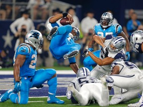 Panthers quarterback Cam Newton is upended and lands in the end zone for a touchdown against the Cowboys during second half NFL action in Arlington, Texas on Thursday, Nov. 26, 2015. (AP Photo/Brandon Wade)