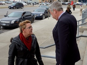 David Rock, outside the London Courthouse after being convicted of possessing child pornography, is confronted Thursday on the courthouse steps by Christine Ellis-Mabeth, the sister of his former girlfriend who died a year ago. (MORRIS LAMONT, The London Free Press)