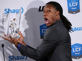 Derel Walker clowns for the media after receiving his award at the CFL's gala in Winnipeg Thursday night. (Al Charest, Postmedia Network)