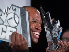 Ottawa RedBlacks quarterback Henry Burris poses for photographs after winning the CFL's most outstanding player award and Tom Pate memorial award during the Canadian Football League awards in Winnipeg on Thursday November 26, 2015. THE CANADIAN PRESS/Darryl Dyck