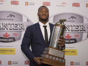 David Onyemata, of the University of Manitoba, holds the J.P. Metras Trophy as the most outstanding down lineman of the year during CIS Awards gala, Thursday, November 26, 2015 in Quebec City. THE CANADIAN PRESS/Jacques Boissinot