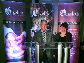 First ever CARRT team Pam Thomppson and Brian Robertson speak on their experiences during CARRT's 20th anniversary at the Zebra Child Protection office in Edmonton, Alberta on November 25, 2015.  Wren a canine intervention assistance dog lays in front of the podium.