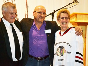 t the Rotary Club of Mitchell's Rural Urban Night last Thursday, Nov. 26, Rotary President Bert Vorstenbosch, Sr. (left) and Rotarian Mark Moore presented Ontario Premier Kathleen Wynne with an honorary Mitchell Hawks jersey. The junior C hockey club marks their 50th anniversary next season. An estimated 275 people attended the event.  GALEN SIMMONS/MITCHELL ADVOCATE