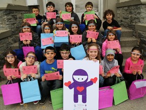 TIM MILLER/THE INTELLIGENCER
Students from Queen Victoria School show off their Royal Kindness Ninja headbands and leaflets on Friday in Belleville. The initiative saw the students performing random acts of kindness and urging others to pay those forward.