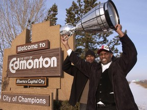 2003 Grey Cup. Edmonton Eskimos linebacker Olanzo Jarrett (left) and Eskimos  wide-receiver Ed Hervey stopped to have their picture taken at the City of Champions sign on QE II shortly after landing back in Edmonton from Regina, Sask., on Monday Nov. 17, 2003. The Eskimos beat the Montreal Alouettes 34-22 at Taylor Field in front of 50,909 fans to win the CFL's 91st Grey Cup game.  Edmonton Sun