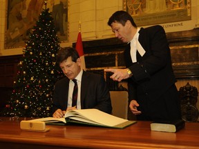 Audra Kent/Special to The Intelligencer
Mike Bossio makes his swearing in official under the eye of Acting Deputy Clerk André Gagnon on Wednesday in Ottawa.