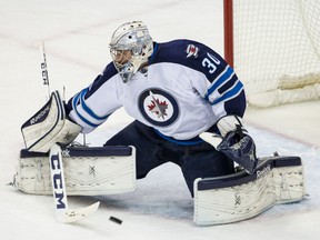 Winnipeg Jets goalie Connor Hellebuyck (30) makes a save during his first career start against Minnesota Nov. 27, 2015.