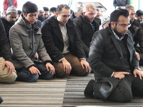 Momin Saeed leads nearly a hundred Edmonton Muslims in a prayer for victims of terrorist attacks at the Edmonton Federal Building on Thursday, Nov. 27, 2015. CLAIRE THEOBALD Edmonton Sun