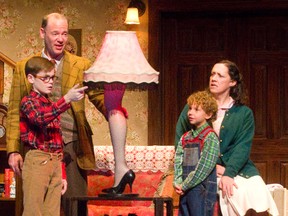 Ralphie played by Callum Thompson and his dad, the ?Old Man? played by Matthew Olver, enjoy the leg lamp more than Ralphie?s mom, played by Sarah Machin Gale, and Randy, played by Isaak Bailey, in the Grand Theatre production of A Christmas Story. (MIKE HENSEN, The London Free Press)