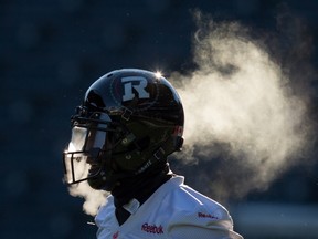 Vapour rises from Ottawa Redblacks' Marcus Henry as he exhales in cold weather during Grey Cup football practice in Winnipeg, Man., on Friday, November 27, 2015. THE CANADIAN PRESS/Darryl Dyck