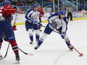 Mikkel Aagaard, right, of the Sudbury Wolves, prepares to fire the puck at the Hamilton Bulldogs net during OHL action at the Sudbury Community Arena in Sudbury, Ont. on Friday November 27, 2015. John Lappa/Sudbury Star/Postmedia Network