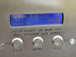 A photo taken on November 18, 2015 shows the intercom displaying the name of Fabien Clain outside the building where Clain, a French man identified as the voice in an audio recording claiming responsibility for the Paris attacks, lived in Alencon, north-western France. Speaking for the Islamic State group, Clain's chilling propaganda audio warns that the rampage that left 129 dead on November 13 was just "the beginning of the storm". Thought by security sources to be 37 years old, Clain is not a so-called "Facebook jihadi" with cursory religious indoctrination, but someone with sufficient stature to be a mentor among the some 850 French and Belgian militants in Syria. AFP PHOTO / JEAN-FRANCOIS MONIER