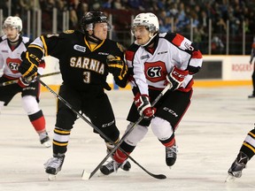 Jeff King of the Sarnia Sting and Ottawa 67's forward Ben Fanjoy collide during OHL action at TD Place on Friday, Nov. 27, 2015. (Chris Hofley/Ottawa Sun)