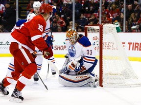 Nov 27, 2015; Detroit, MI, USA; Edmonton Oilers goalie Cam Talbot (33) makes the save on Detroit Red Wings center Riley Sheahan (15) in the first period at Joe Louis Arena. Mandatory Credit: Rick Osentoski-USA TODAY Sports