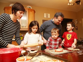 Laura and Mark Gregorini prepare dinner with their children, Chiara, 5, Tommaso, 2, and Alessandro, 7. Gino Donato/Sudbury Star
