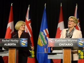 Alberta Premier Rachel Notley (left) and Ontario Premier Kathleen Wynne during a media availability at Queen's Park in Toronto, Thursday, Oct, 1, 2015. THE CANADIAN PRESS/Marta Iwanek