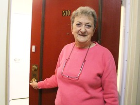 Dorothy Williams opens the door at her Kenwick Building apartment Saturday in Sarnia. Williams, who's lived in the building 32 years, was displaced along with hundreds of others after a fire a little under a week earlier. Many of them returned home Saturday. Tyler Kula/Sarnia Observer/Postmedia Network