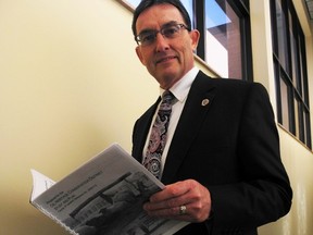 Robert Tremain, the county's general manager of cultural services, reviews material used to support the creation of Lambton's Oil Heritage District. After a 38-year career in the county's cultural services division, Tremain will retire Jan. 4. Barbara Simpson/Sarnia Observer/Postmedia Network