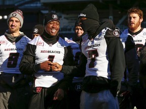 Ottawa RedBlacks quarterback Henry Burris (1) stands with Maurice Price (7) and Danny O'Brien (L) during their team's walkthrough practice ahead of the CFL 103rd Grey Cup championship football game in Winnipeg, Manitoba, Canada, November 28, 2015.    REUTERS/Mark Blinch