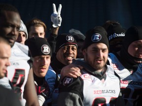 Ottawa RedBlacks quarterback Henry Burris, centre, is seen as he and the team take a group photo during a team walk through in Winnipeg, Man. Saturday, Nov. 28, 2015. The Edmonton Eskimos will play the Ottawa Redblacks in the 103rd Grey Cup Sunday. THE CANADIAN PRESS/Nathan Denette