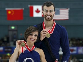 Meagan Duhamel (left) and Eric Radford (right) show off their gold medals during the presentation ceremony at the ISU Grand Prix of Figure Skating in Nagano, Japan, on Saturday, Nov. 28, 2015. (Yuya Shino/Reuters)