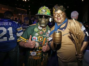 Edmonton Eskimos Section O fan club co-founder Matt Machado, left, poses for a picture with a Winnipeg Blue Bombers fan at the Touchdown Manitoba event during the Grey Cup Festival at the RBC Winnipeg Convention Centre on Fri., Nov. 27, 2015. Kevin King/Winnipeg Sun/Postmedia Network
